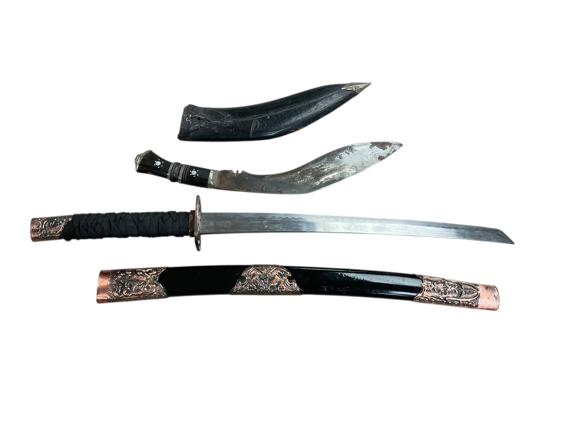 Eastern Kukri knife in leather scabbards, together with a reproduction sabre, in a lacquered scabbard with copper detail, Kukri L40cm  