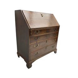George III oak fall front bureau, the interior fitted with hidden compartments, drawers and pigeon holes, four long graduating drawers, on bracket feet