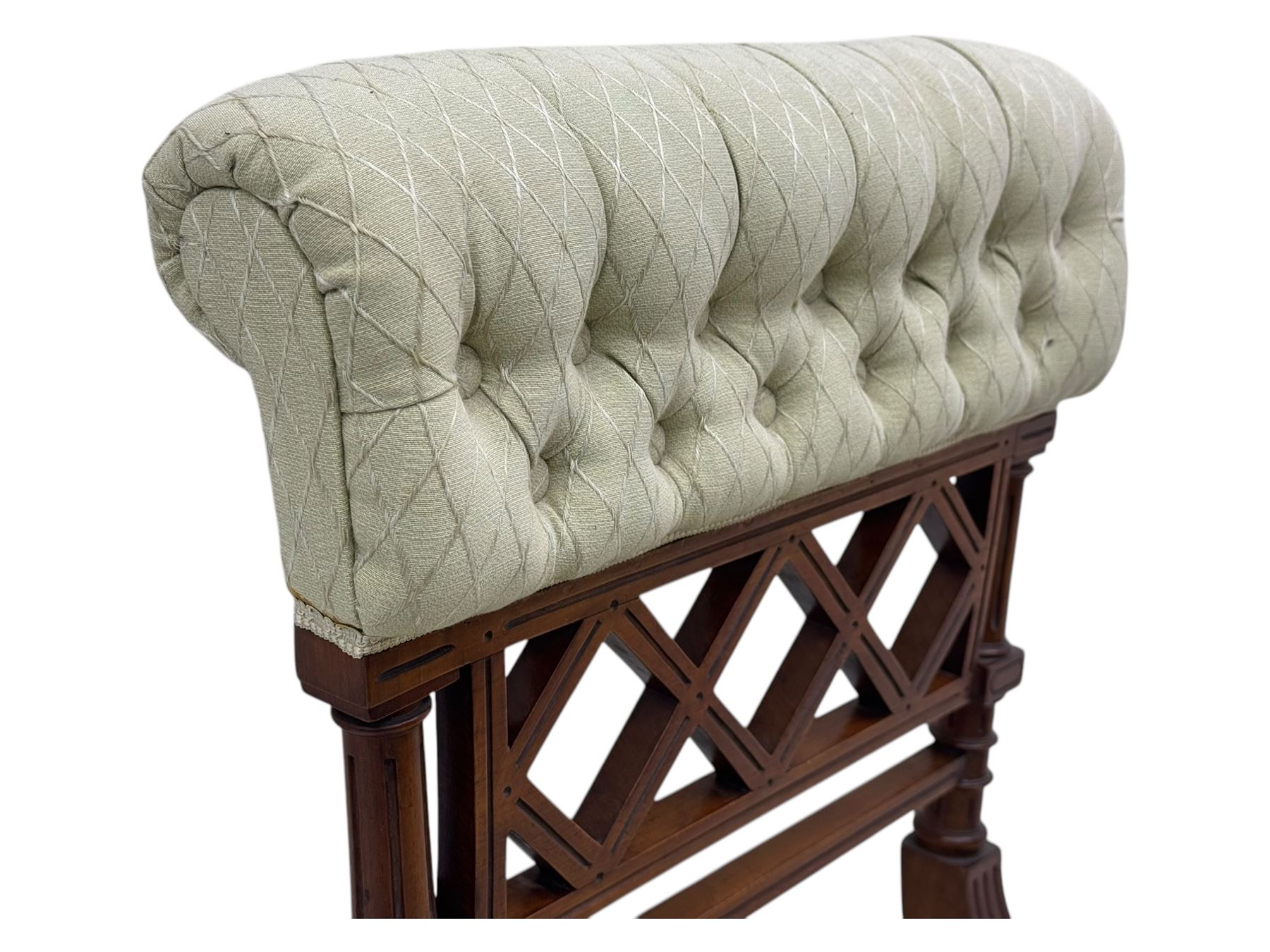 Late Victorian upholstered armchair, with high camel back and deep seat, padded arms and backrest in crimson and cream damask-style fabric, raised on turned ebonised front supports with ceramic castors (H88cm, W65cm, D 60m); and an Edwardian bedroom chair with button upholstered rail back (H72cm, D64cm, W53cm) (2)