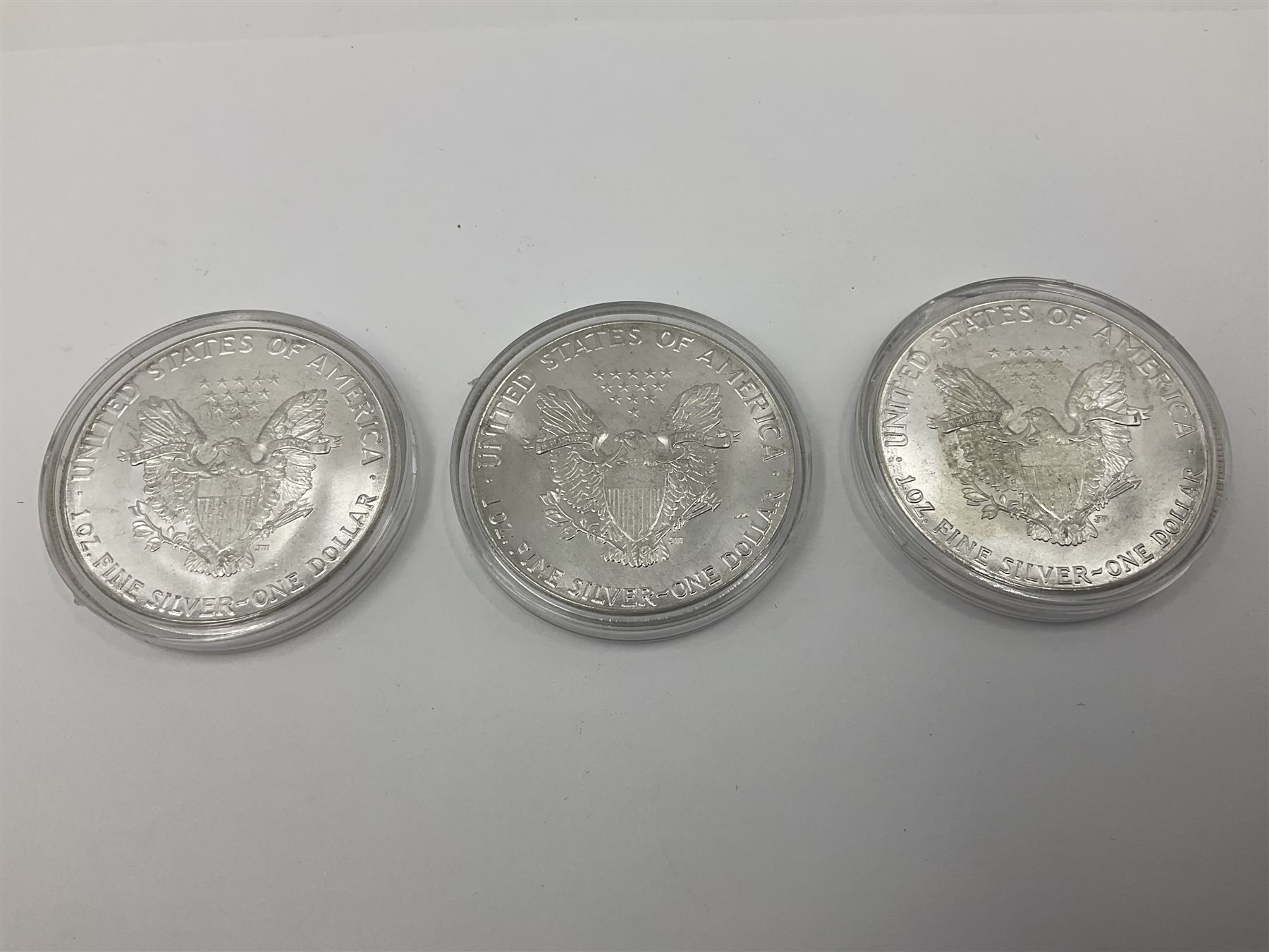 Five United States of America 1oz fine silver one dollar coins, dated 1986, 1987, 1988, 1989 and 1990
