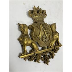 Brass Coat of Arms, the monogrammed shield with Egyptian style hounds with women's heads seated either side, surmounted by a crown, with scrolling foliate detailing, L19cm