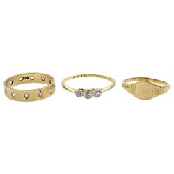 18ct gold three stone diamond ring, 9ct gold star set cubic zirconia eternity ring and a 9ct gold signet ring, all stamped or hallmarked 