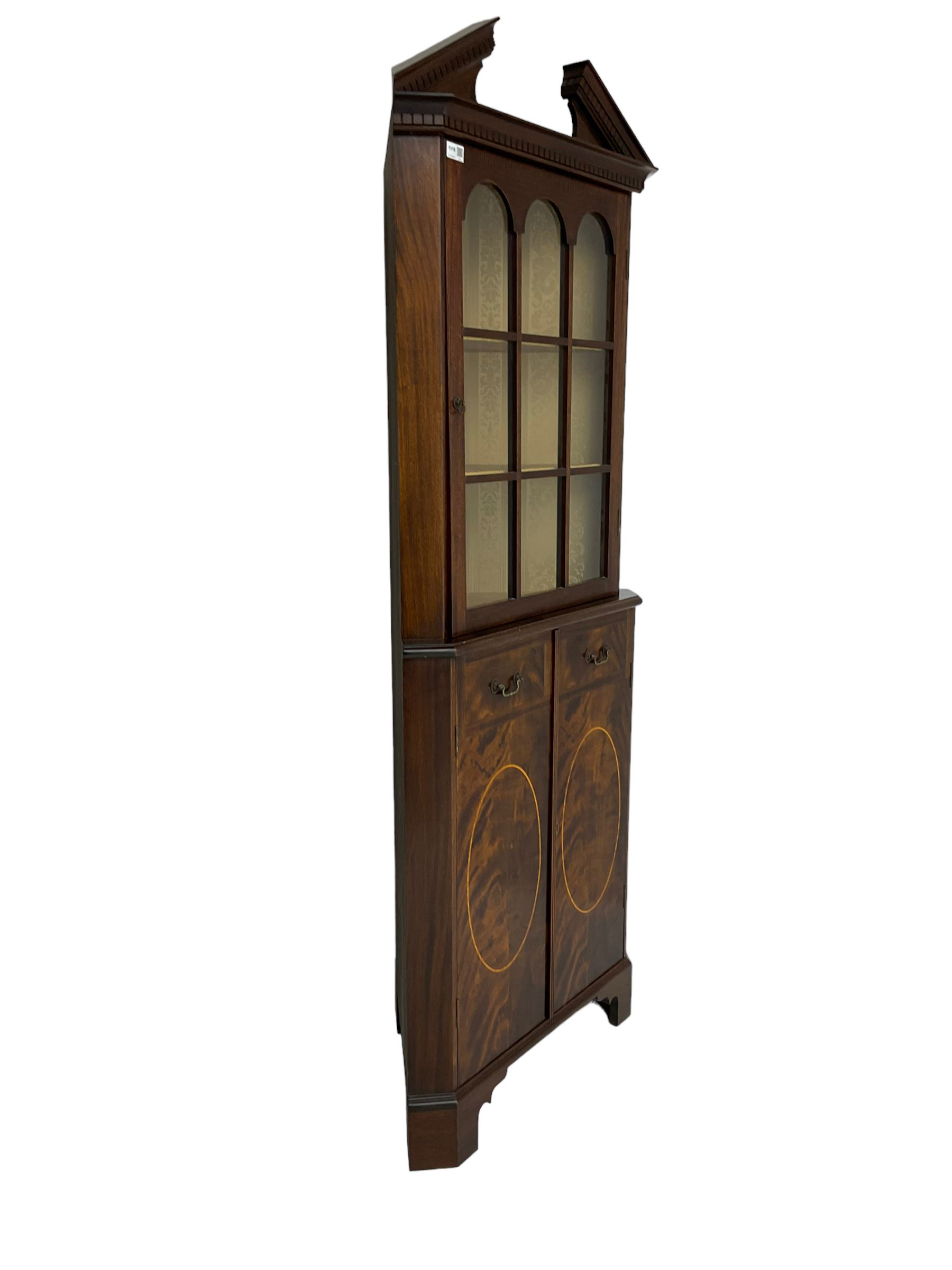 Georgian design inlaid mahogany corner cabinet, broken dentil pediment over single glazed door enclosing two shelves, base fitted with two doors with faux drawer facias