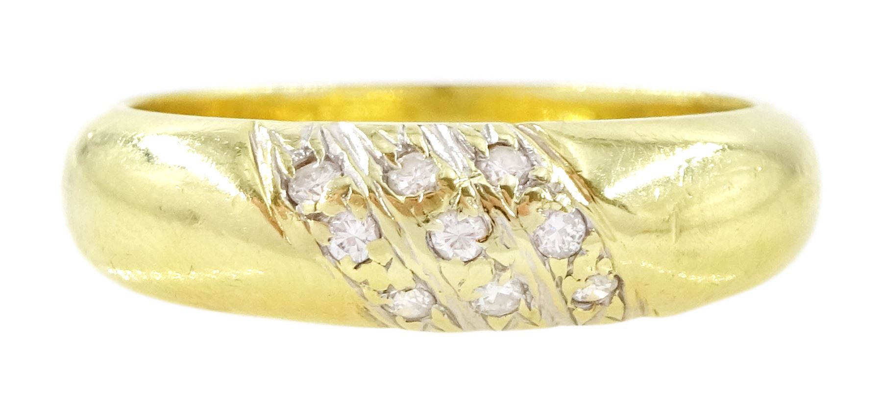 Gold diamond ring, rubover set with nine round brilliant cut diamonds