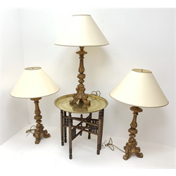  Three Italian giltwood style table lamps on trefoil base with shades, H97cm max (one a/f) and early 20th century circular brass table top on Moorish style folding stand, D58cm, H57cm  