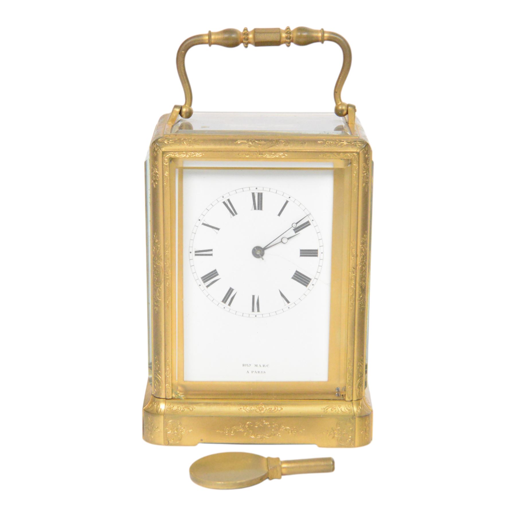 Late 19th century French 8-day brass cased carriage clock, Henry Marc of Paris, the gorge case with swing handle and four bevelled glass panels, white enamelled dial with Roman numerals and minute markers and steel hands, the two train movement with platform lever escapement, hour striking on a bell, with key