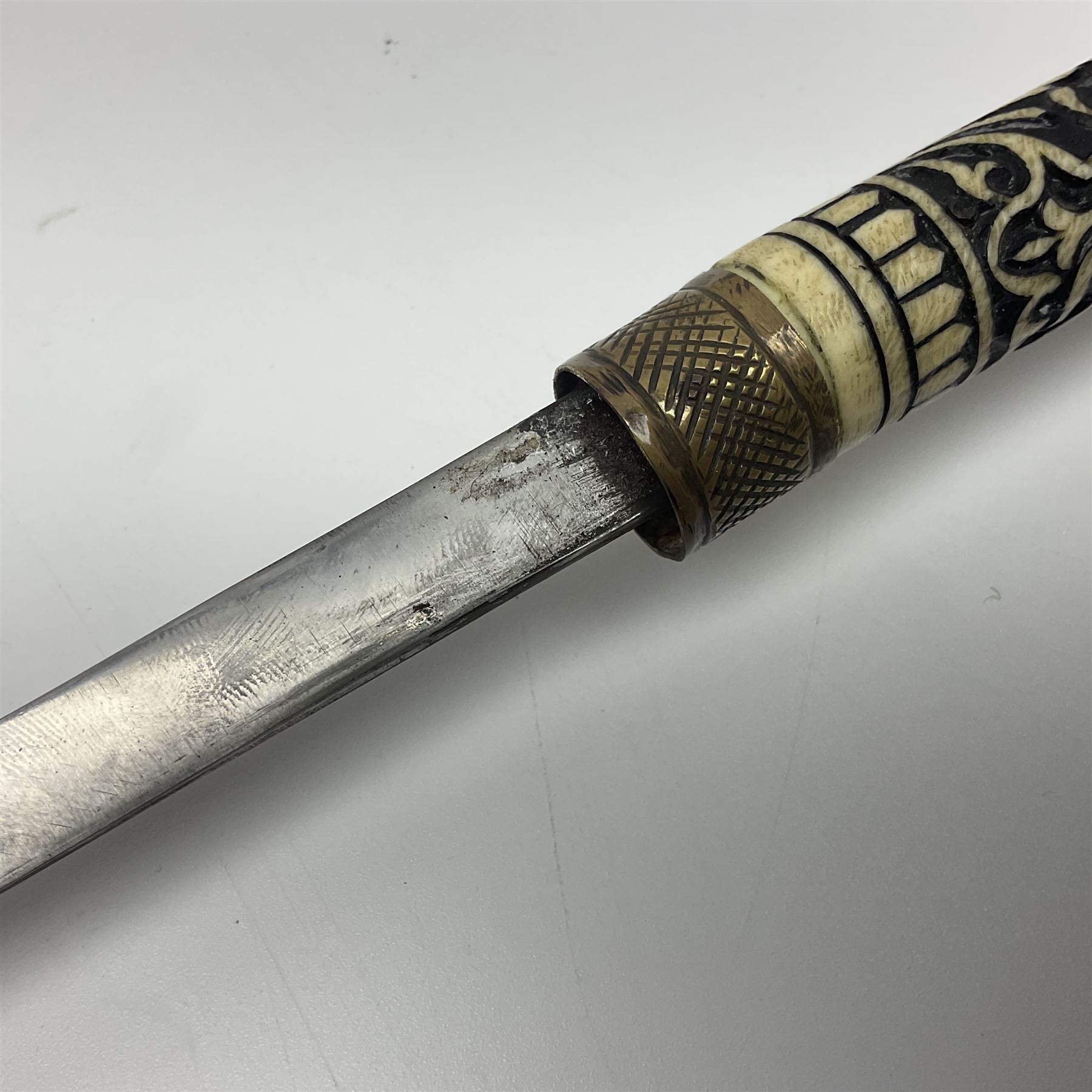 Early 20th century Indian ebonised wooden umbrella sword stick with 36cm blade, carved bone mount and black cloth cover L92cm overall; together with a similar Indian ebonised wooden sword stick with 64cm blade, carved bone mount and brass lion mask pommel L91cm (2)