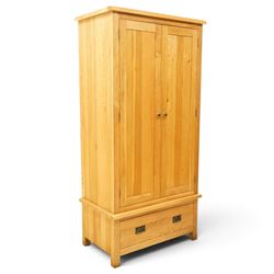 Contemporary light oak double wardrobe, fitted with two panelled cupboards over single drawer
