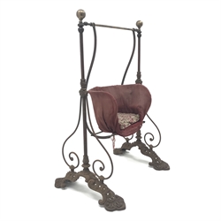  Victorian child's cast iron garden swing, shaped seat on curved supports, the frame with ball finials, scrolled detail and lotus cast feet, H132cm, W80cm  