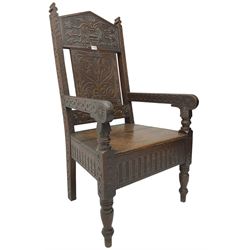 17th century design oak wainscot chair, the back profusely carved with scrolling foliate motifs, the arms carved with repeating guilloche decoration over an arcade apron and turned supports