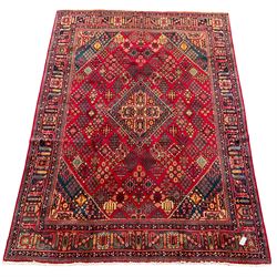 Persian Meimeh red ground rug, the field decorated with central lozenge surround by tree of life star motifs, the border with repeating design decorated with stylised plant motifs
