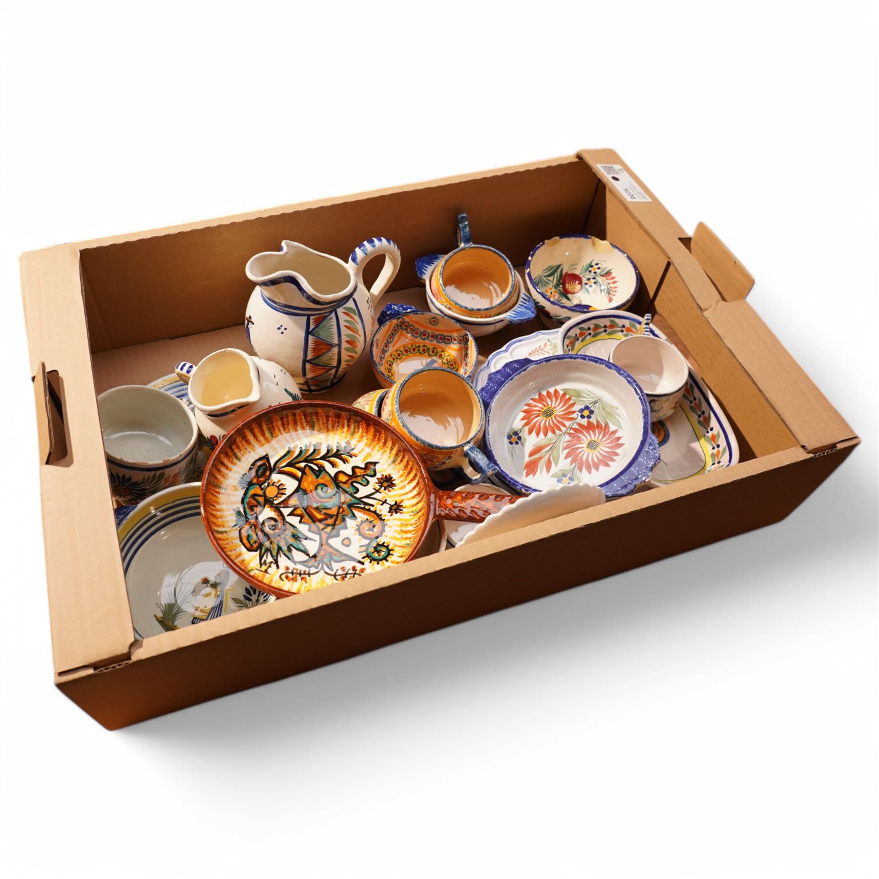 Collection of Quimper faience items including plates, cups, bowls and jug etc