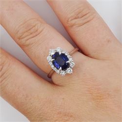 14ct white gold sapphire and diamond cluster ring, single oval cut sapphire of approx 1.00 carat, with round brilliant cut diamond surround, total diamond weight approx 0.40 carat