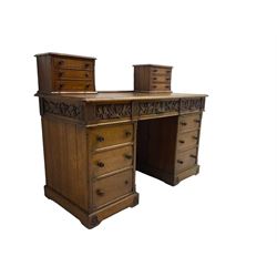 Late 19th century heavily carved oak twin pedestal desk, rectangular top with two raised trinket or correspondence structures each with three drawers, rectangular top over three frieze drawers carved with acorn and oak leaf decoration, each pedestal with three drawers with acorn husk shaped handles