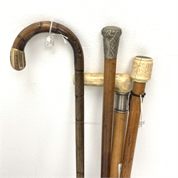 A collection of four walking canes, to include a bone handled example upon Malacca cane, and another marked Royal Army Medical Corps, together with a large copper twin handled pan, three bed warming pans, a table lighter modelled as a footballer kicking a large football, etc. 