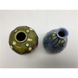 Minton Secessionist vase, with tube-lined stylised flower head decoration on a blue ground, printed mark to base 'Minton Ltd, No. 30', together with another Minton Secessionist tubelined vase,  printed mark to base 'Minton Ltd, No. 16', tallest example H13.5cm