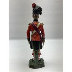 Sitzendorf figure, The Black Watch officer, c1815 standing to attention in full dress with sword, blue factory marks beneath, H28cm