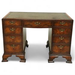 Early 20th century inlaid mahogany pedestal kneehole desk, rectangular top with inset tooled leather writing surface, over an arrangement of nine drawers with brass swan neck handles, on ogee bracket feet