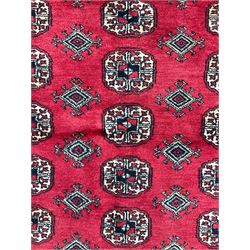 Turkmen Tekke Bokhara rug, red ground and decorated with Gul motifs, repeating multi-band border, signed on corners 