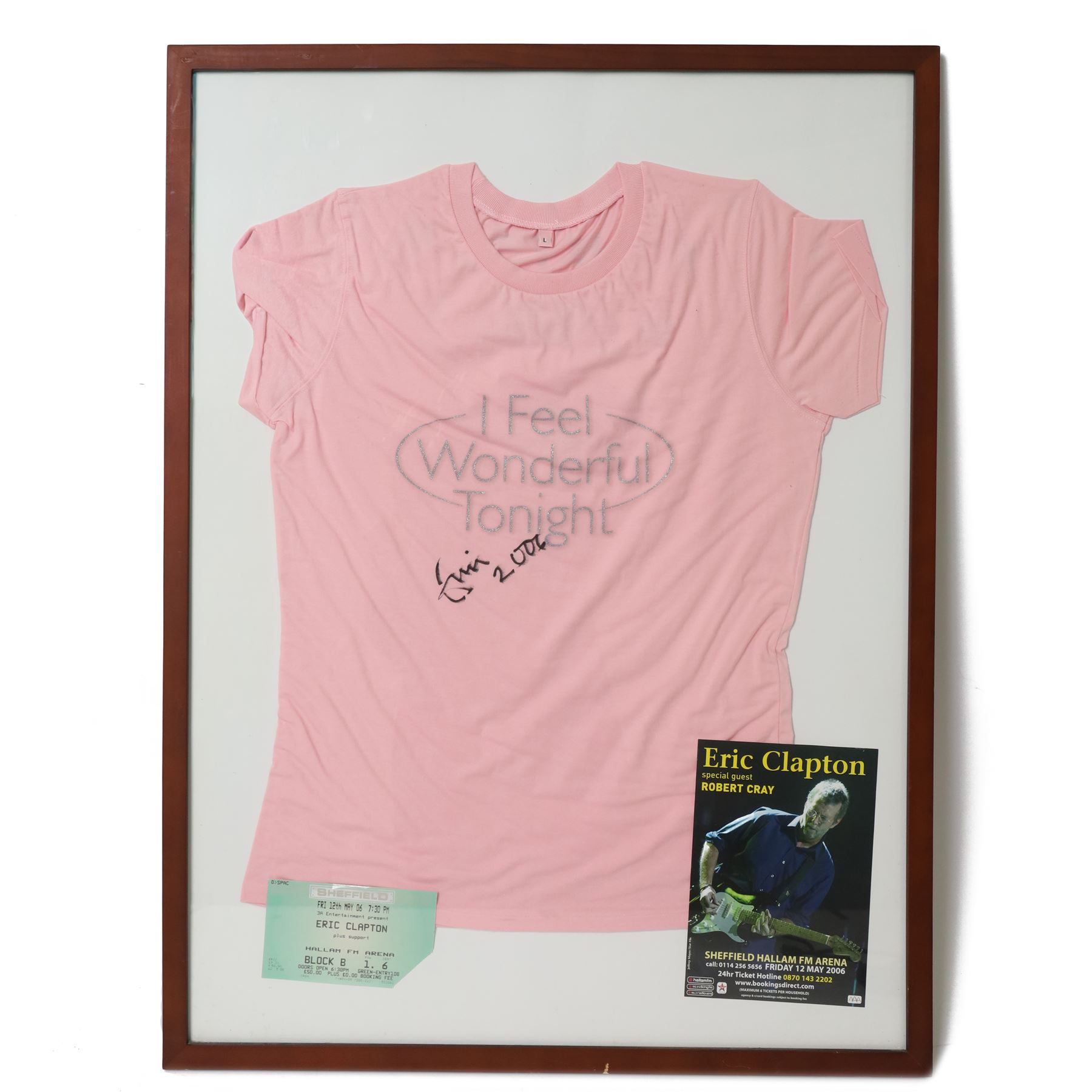 Signed Eric Clapton 2006 tour t-shirt, pink t-shirt with 'I Feel Wonderful Tonight' in silver lettering, signed by Eric Clapton in black marker to front, in framed display with ticket and programme, frame H83cm