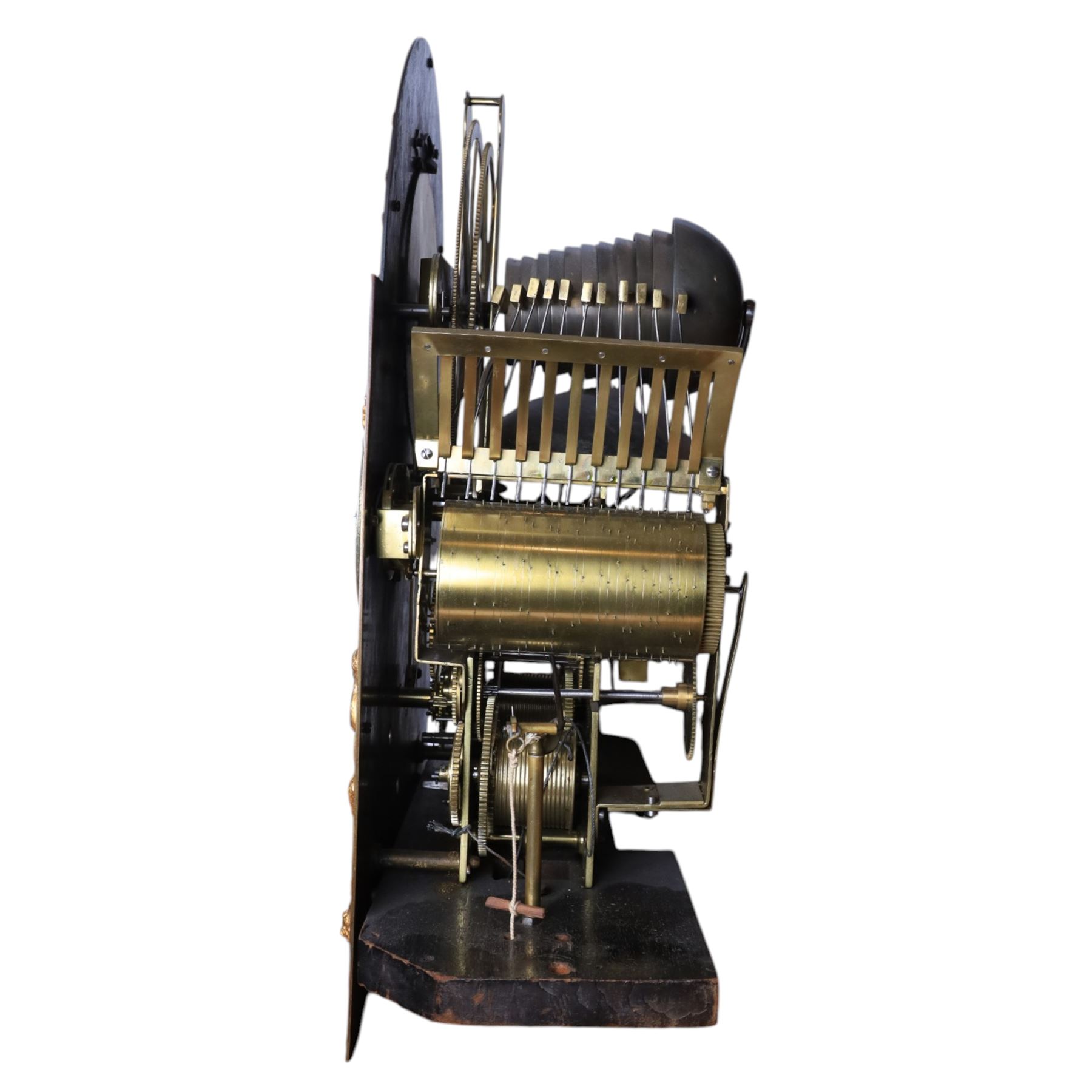 Late nineteenth century ebonised and gilt-bronze mounted musical longcase clock of impressive architectural form, the case of ebonised finish with applied gilt bronze neoclassical inspired masks and mounts, hood of arched form with glazed door, flanked by free fluted columns with gilt bronze Corinthian capitals surmounted by stylized Lion finials, frieze and arch enriched with applied foliate mounts, trunk with a rectangular glazed door bordered by mouldings and flanked by engaged columns with gilt bronze mounts above a shaped projecting base panel with applied central female mask and corner foliate ornamentation, arched brass dial, with a silvered chapter ring and applied cast gilt bronze spandrels and arch decoration, incorporating subsidiary selection dials for chime/silent and tune regulation, offering Cambridge chimes on eight bells and an additional chime sequence on ten bells, brass arch is further embellished with a moon phase aperture with lunar calendar scale, Zodiac symbols, month and date indication on a silvered dial, substantial eight-day, three-train movement with pinned cylinder musical train and a graduated nest of eleven bells with eleven hammers, quarter chiming with separate hour/half-hour strike and chime repetition, movement is regulated by an anchor escapement, with brass disc pendulum, three brass weights, two winding keys and case door key