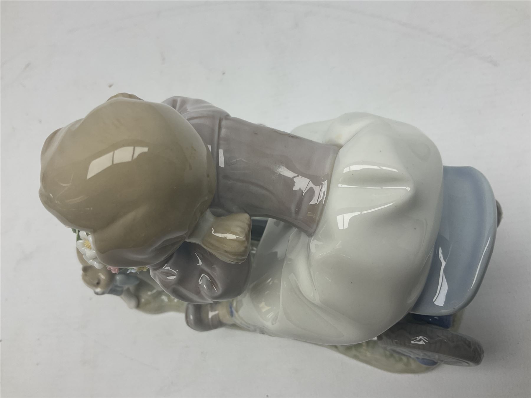 Lladro figure, In No Hurry, modelled as a girl on a tricycle, sculpted by Francisco Polope, with original box, no 5679, year issued 1990, year retired 1994, H15cm