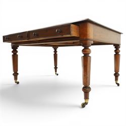 Mid Victorian four drawer mahogany partners' writing table, with leather inset top with moulded edge, with two frieze drawers to either side, on turned supports terminating in castors