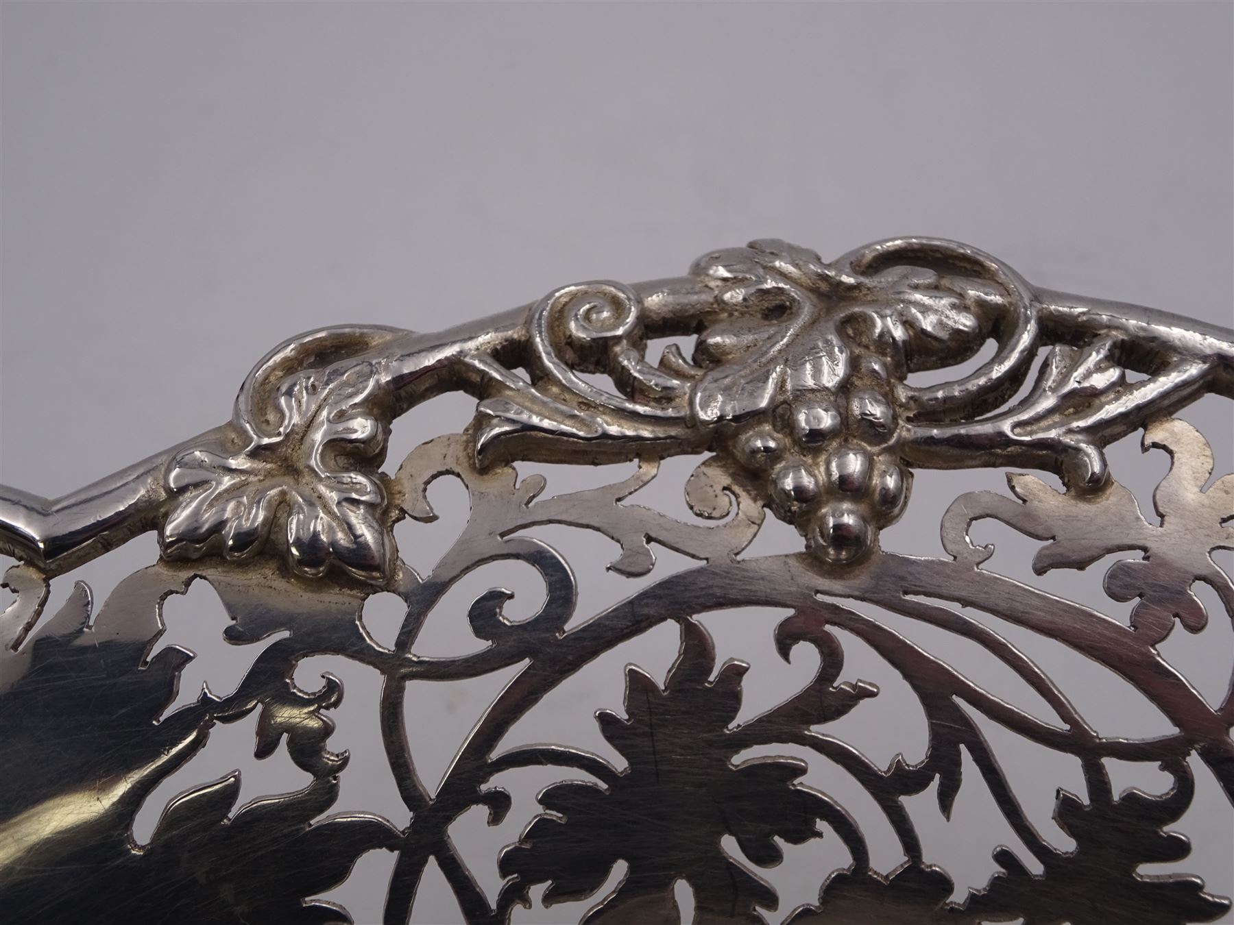 Modern silver Britannia standard fruit bowl, of lobed circular form, with applied and pierced fruiting vine decoration throughout, upon three bracket feet, hallmarked 1966, maker's mark BSC