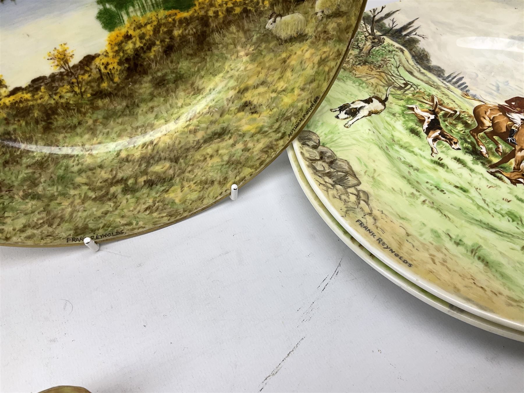 Four Frank Reynolds figures of ladies together with five plates painted by the same artist