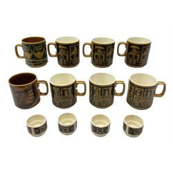 Collection of 1970s Hornsea mugs designed by John Clappison, comprising six Train Robber pattern examples together with owl patterned example on dark teal ground, and further example decorated with stylised hen and chick and egg, approx 9cm, together with four small cup bowls, all with stamped Hornsea marks beneath
