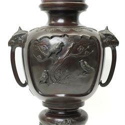 Japanese late Meiji period bronze koro and cover, surmounted by an eagle finial and with bird decoration in high relief to each side, twin elephant trunk handles, bearing indistinct character signature to one side, H82cm