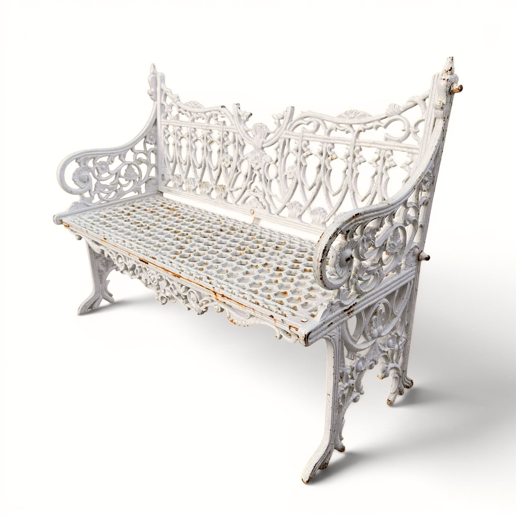 Victorian revival heavy cast iron garden bench, ornate back rest with scrolls, floral motifs and central crest, pierced lattice seat, curved arms and decorative legs, painted in antique white, in the Gothic Coalbrookdale style - Damaged 