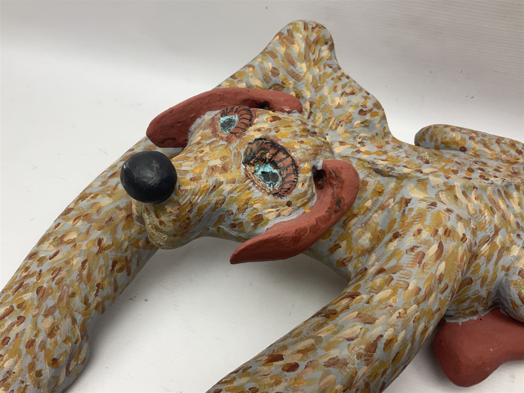 Helen Skelton (British 1933 – 2023): Two carved wooden abstract sculptures, one modelled as a dog, the other modelled as a bear, both with painted stippled decoration, largest H20cm. Born into an RAF family in 1933 in Kent and travelled the world extensively during her childhood. After settling in Bridlington, Helen immersed herself in painting, textiles, and wood sculpture, often inspired by nature's beauty. Her talent was showcased in a one-woman show at Sewerby Hall and recognised with the sculpture prize at Ferens Art Gallery in 2000. Sadly, Helen’s daughter passed away from cancer in 2005. This loss inspired Helen to donate her sculptures to Marie Curie upon her passing in 2023.