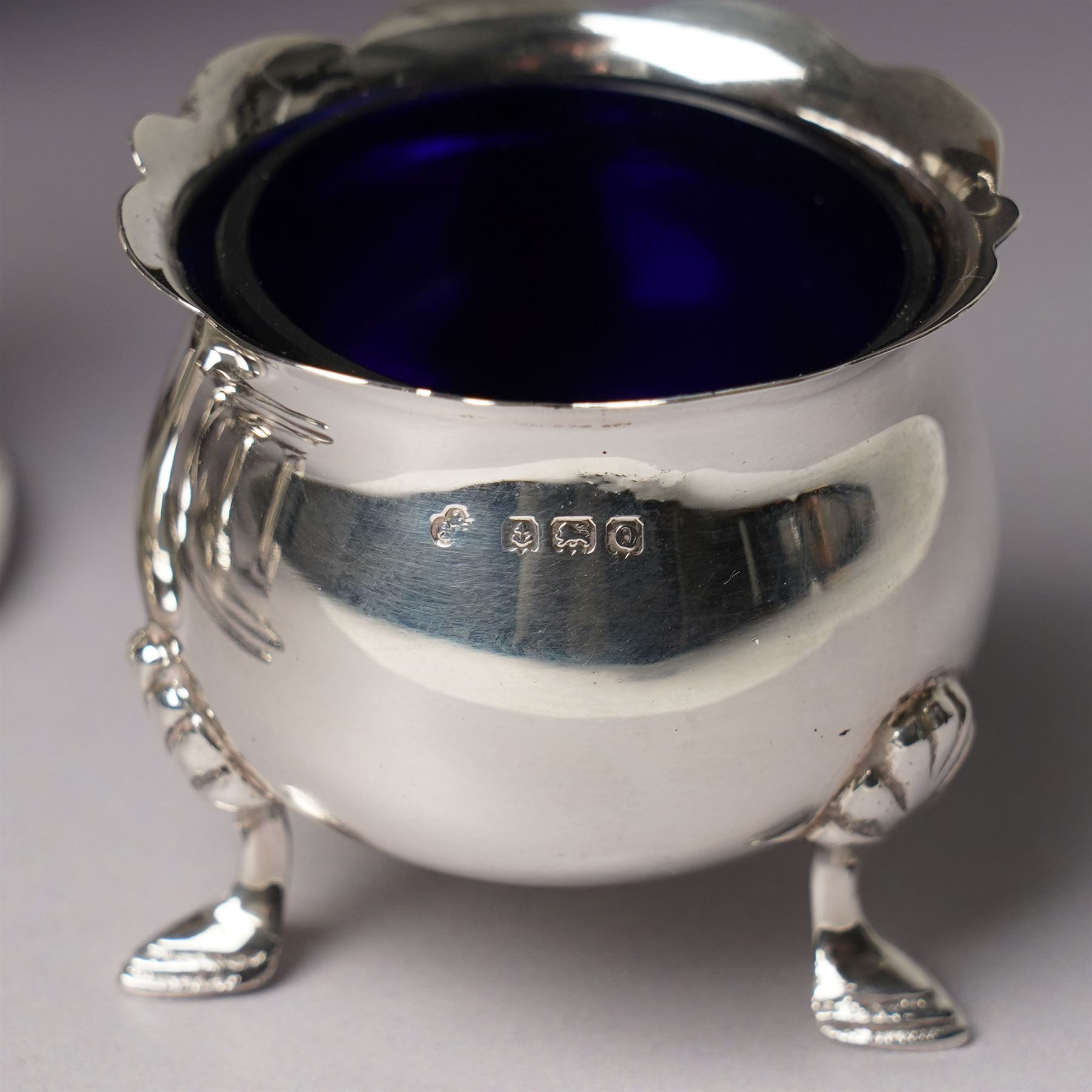 Georgian design silver cream jug Birmingham 1901 Maker George Unite, three piece silver condiment set Birmingham 1940, pair of small silver dressing table candlesticks and three condiment spoons