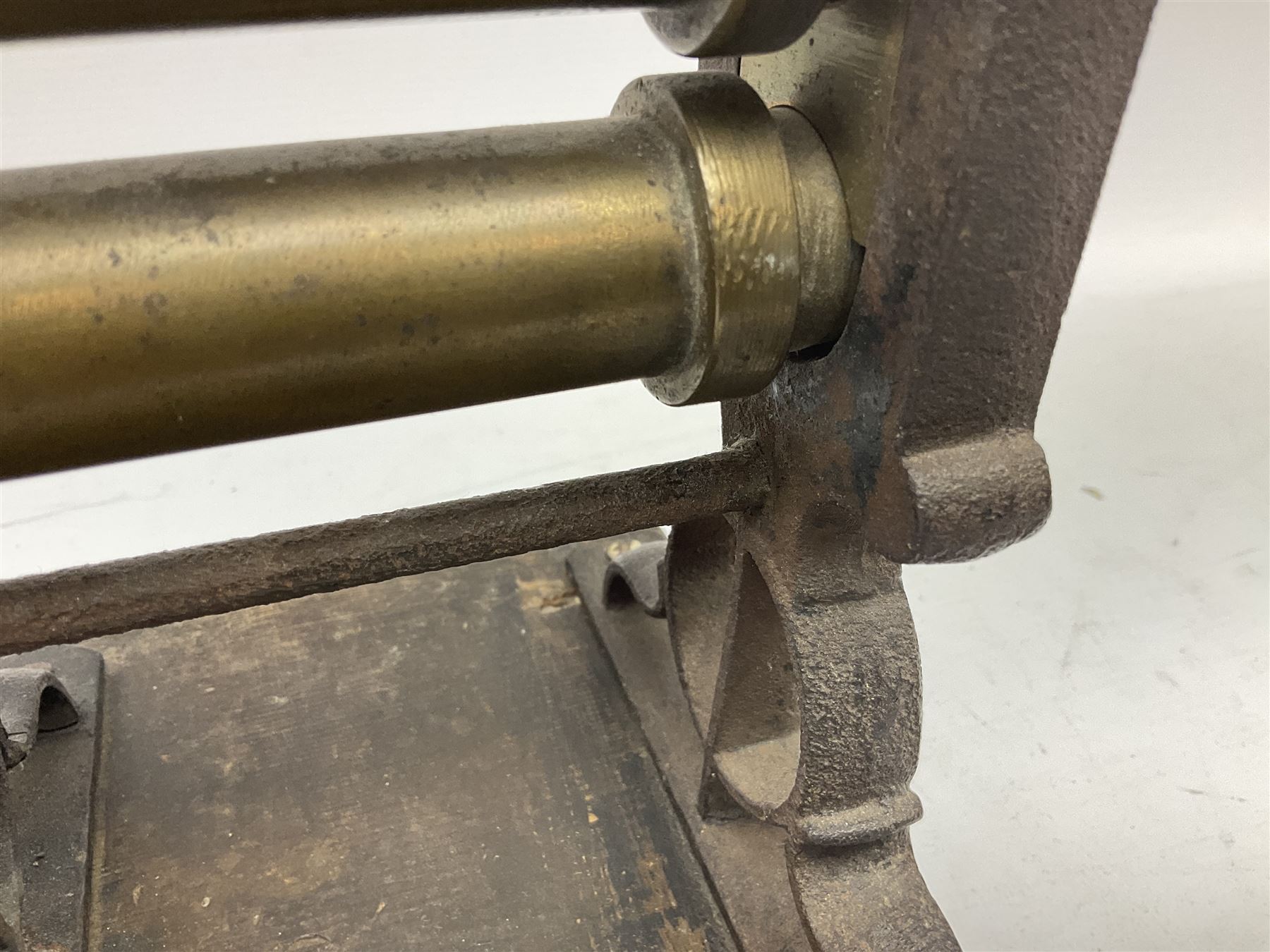 Victorian cuff and collar tabletop mangle, the ribbed brass rollers in a cast iron frame mounted on a wooden base