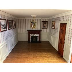 'The Hollies' - good quality sectional wooden doll's house in the form of a Georgian style four-storey bay windowed town house with simulated brick front elevation, rendered sides, off-set corner stonework, faux slate-hung top floor with flat roof and chimney stack, working sash windows, iron railings around front basement courtyard with hinged front elevation to two rooms with  spiral staircase, side hinged central section approached by external steps with iron balustrades to the sides leading to a front door, entrance hall with stairs to landing and two rooms on two floors with dado panelling and fire-surrounds, the top floor with top hung front elevation revealing stairs to a landing and bedroom; wired for electricity L51cm D65cm H107cm including chimney; together with a good quantity of quality wooden furniture and accessories including piano, dressers, bookcase and books, rugs, double half-tester bed, metalware, pictures etc