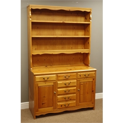  Polished pine dresser, seven drawers and two cupboard, raised plate rack, W112cm, H183cm, D48cm  