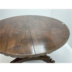 Early Victorian rosewood circular tilting dining table, turned column support on trefoil base with carved scrolling feet