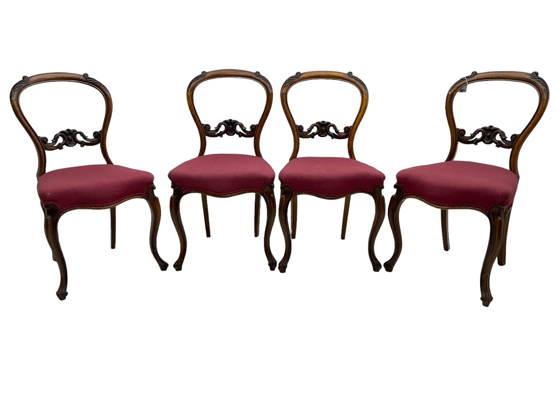 Set of six Victorian rosewood dining chairs, the balloon back carved with foliage scrolls, cartouche carved middle rail with extending scrolls, the seats upholstered in pink fabric, on carved cabriole supports with scrolled terminals 