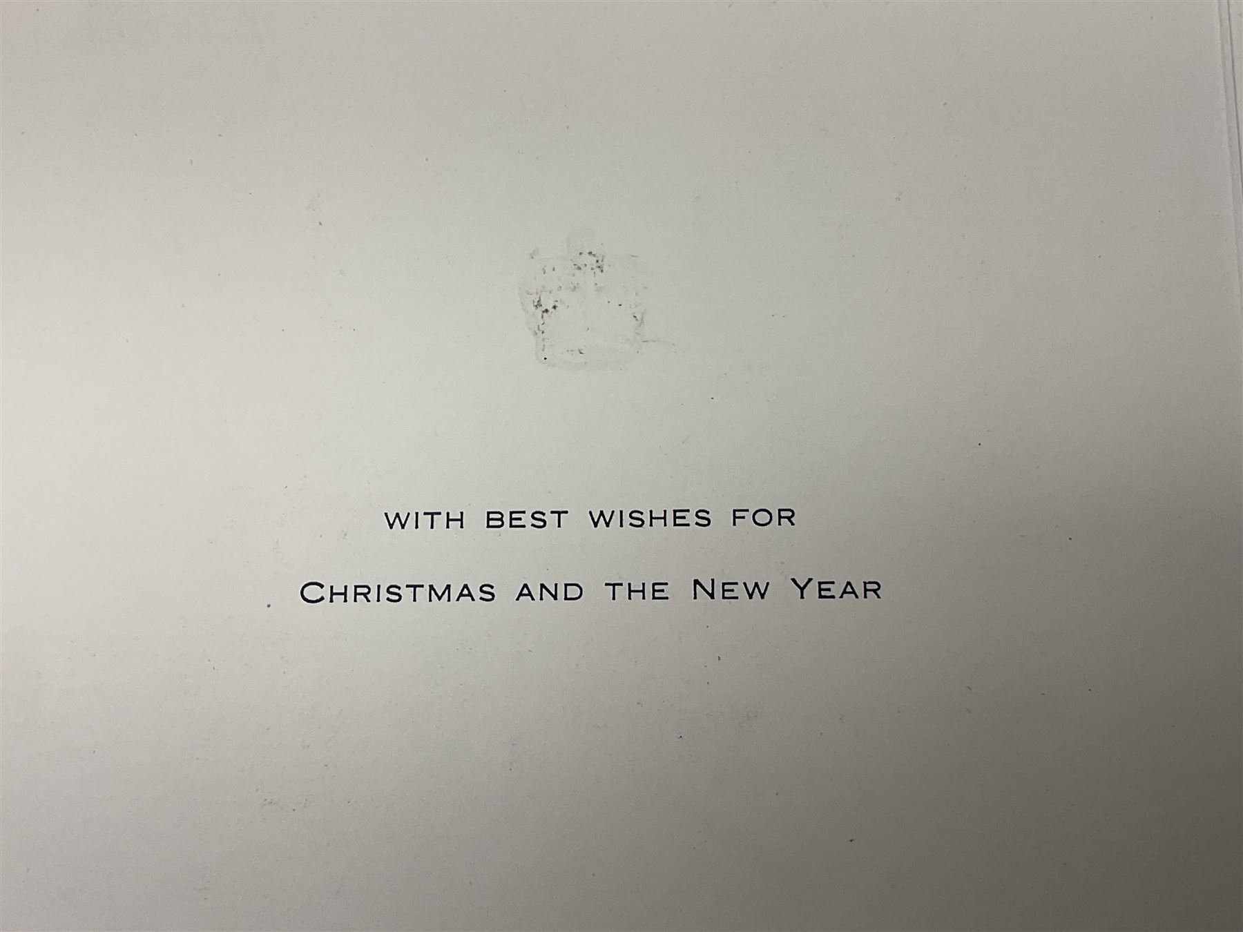 HM Queen Elizabeth II and HRH The Duke of Edinburgh - signed 1956 Christmas card with gilt embossed crown to cover, black and white photograph of the smiling Royal Couple with Prince Charles and Princess Anne on board Britannia, signed in ink 'Philip 1956 Elizabeth R',