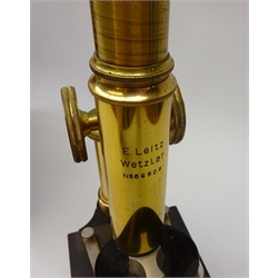  E Leitz Wetzlar black japanned and lacquered brass monocular microscope No.86926, rack & pinion coarse and fine adjust, three objective turret on horse shoe base with additional ocular, retailed by W Watson & Sons, in fitted mahogany case, H28cm, case, H34cm  