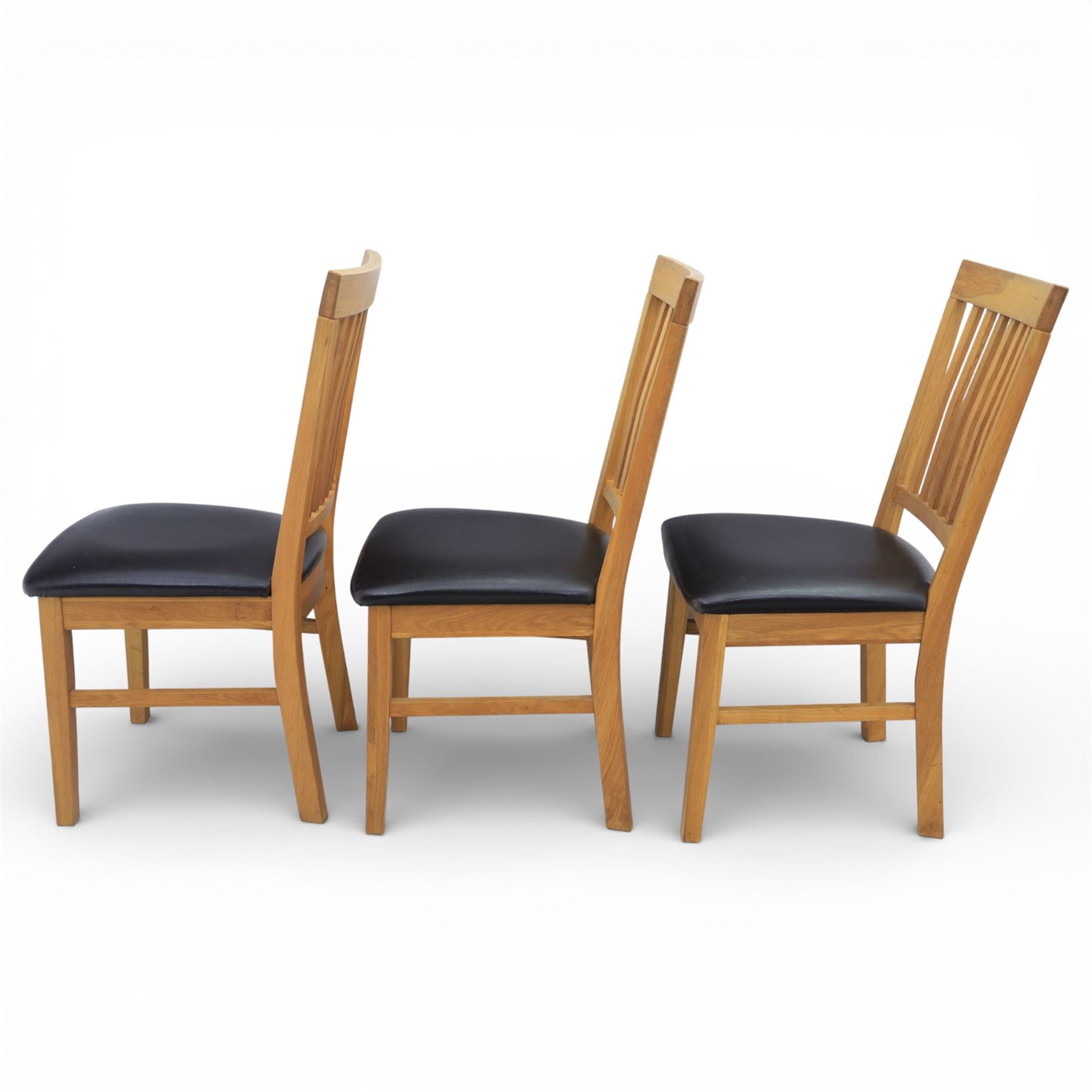 Solid light oak extending dining table with single leaf, and set of six chairs