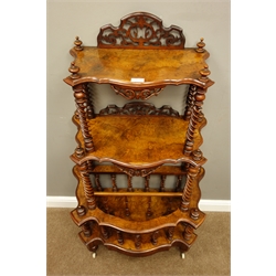  Victorian figured walnut shaped three tier what-not Canterbury, barley twist supports, pierced and carved gallery backs, drawer to base, ceramic castors, W76cm, H130cm, D41cm  