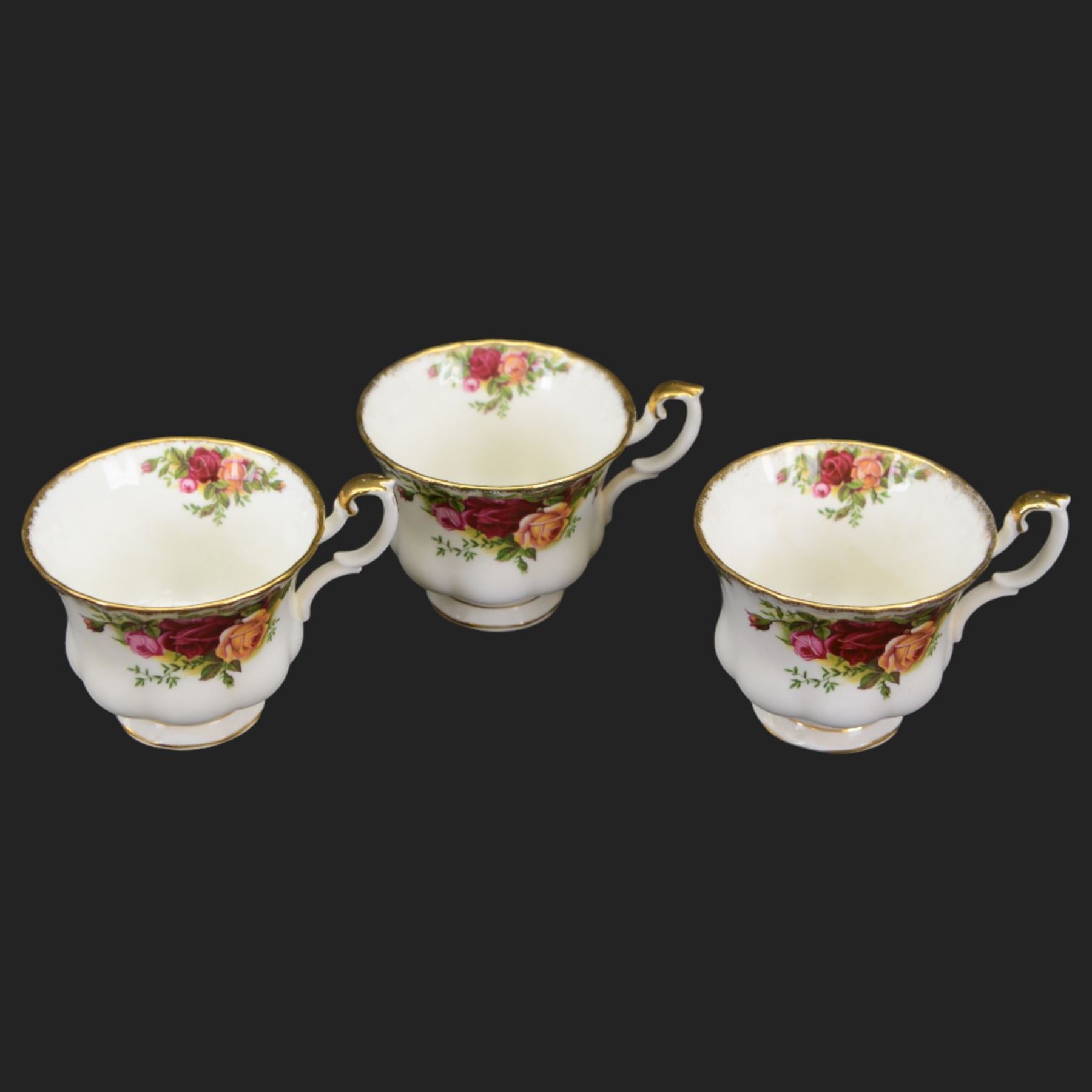 Royal Albert Country Roses tea and dinner service for six place settings, comprising teapot, milk jug, cups and saucers, dessert plates, side plates and dinner plates, all with printed mark beneath 