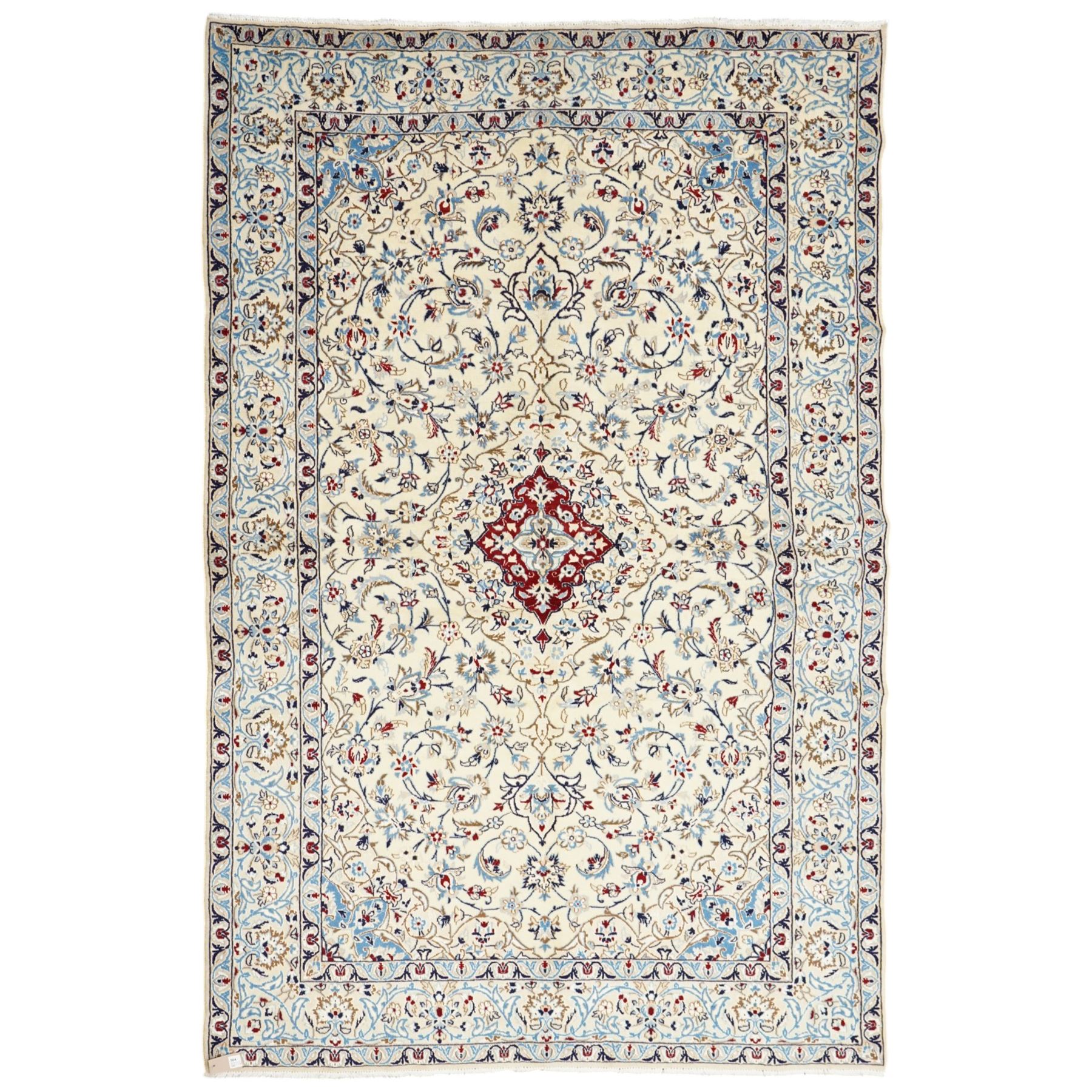 Central Persian Nain hand-knotted rug, ivory field with central medallion in tones of indigo and blue, issuing vinery, palmettes and floral sprays with conforming spandrels, dark blue main border of floral vinery and stylized palmettes, framed by multiple guard borders, with cotton fringe ends 