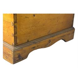 Late 19th century stripped pine blanket box, rectangular hinged lid enclosing main compartment with fitted candle box, wrought iron strap hinges and lock, black-painted side handles, on a shaped plinth base