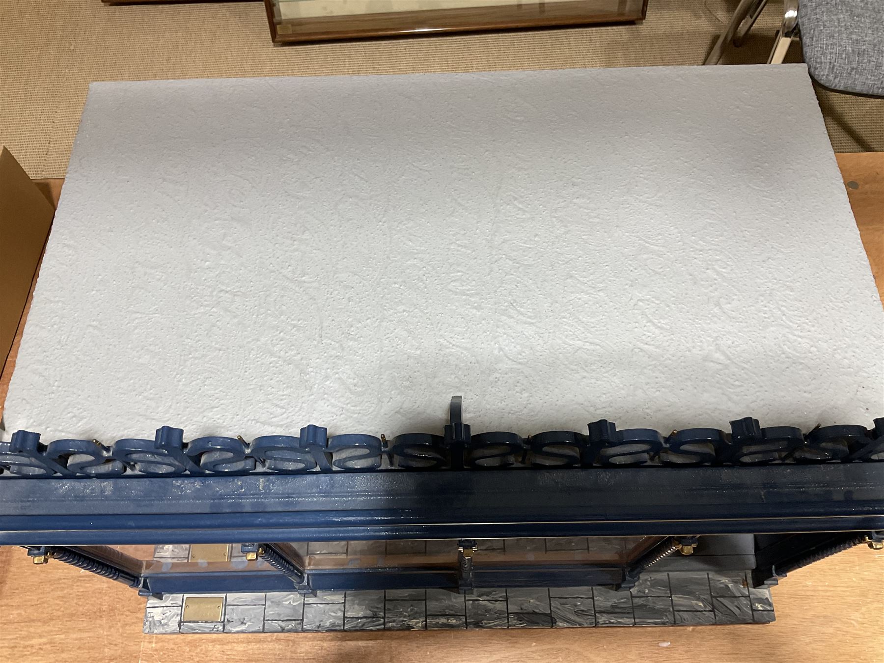 Good quality late 20th century dolls house by M. James dated 1995 in the form of a Beverley East Yorkshire Antique Shop called 'North Bar Antiques'; single-storey single-roomed shop with textured brick walls and flat roof, fully glazed hinged front with recessed hinged customer door and central window to the rear; comprehensively furnished with chests of drawers, pedestal desk, breakfast table, lowboy, two longcase clocks, delft rack with ceramics, occasional tables, pictures, Regency style mirror and collectibles; decorated walls with coving and picture rail and simulated floorboarding; wired for electric lighting; maker's plaque W61cm H42.5cm D41.5cm