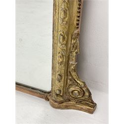 19th century giltwood and gesso overmantel mirror, pediment set with open laurel leaf wreath, egg and dart frame with outer bead and moulded inner slip, the top corners arched and canted, scrolled lower brackets 