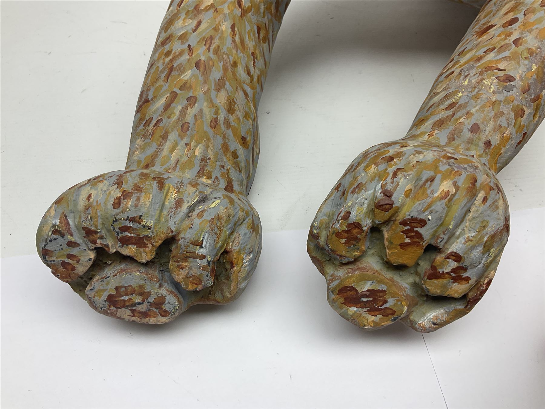 Helen Skelton (British 1933 – 2023): Two carved wooden abstract sculptures, one modelled as a dog, the other modelled as a bear, both with painted stippled decoration, largest H20cm. Born into an RAF family in 1933 in Kent and travelled the world extensively during her childhood. After settling in Bridlington, Helen immersed herself in painting, textiles, and wood sculpture, often inspired by nature's beauty. Her talent was showcased in a one-woman show at Sewerby Hall and recognised with the sculpture prize at Ferens Art Gallery in 2000. Sadly, Helen’s daughter passed away from cancer in 2005. This loss inspired Helen to donate her sculptures to Marie Curie upon her passing in 2023.