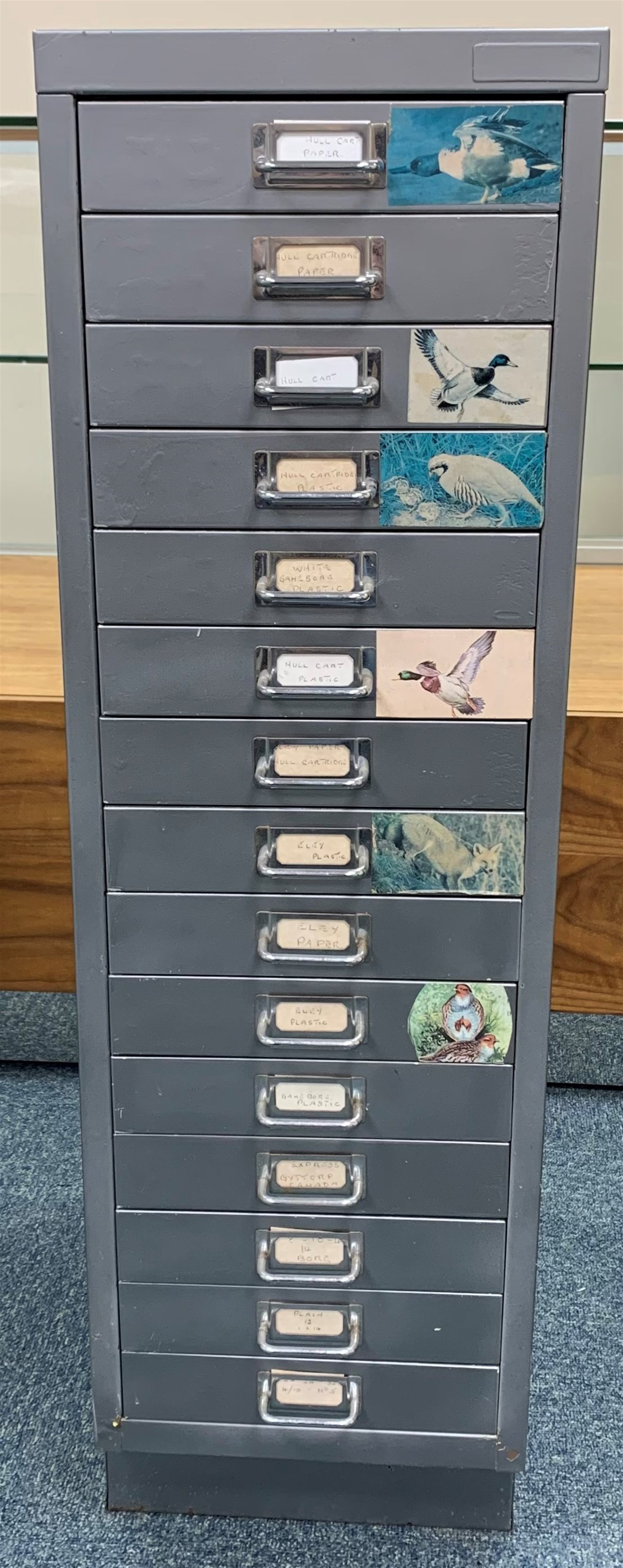 Approximately nine hundred shotgun cartridges, various ages, gauges and makers, contained in grey steel fifteen-drawer cabinet W28cm H94cm D41cm SHOTGUN CERTIFICATE REQUIRED